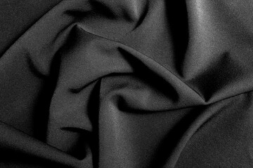 The fabric lies beautifully draped with folds of a bright, rich color.	