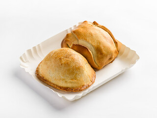 traditional Latin American empanadas on a white cardboard pack for delivery