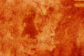 Red orange grunge wall background with light spots.