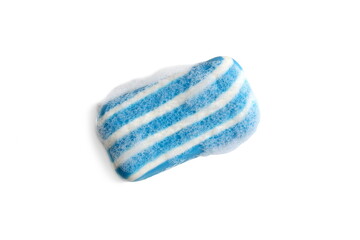  On a white background lies a striped blue soap with foam.