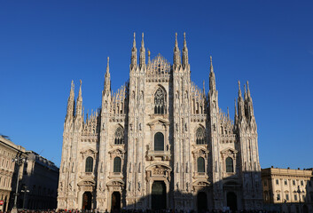 face of the Milan Cathedral in Gothic style with spires in the Lombardy Region in Northern Italy