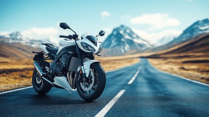 Obraz premium White sportbike on scenic mountain road.