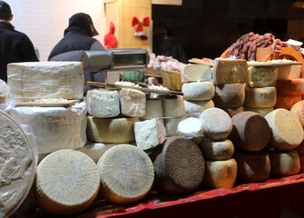 stall with many fresh and aged cheeses, including those made from sheep's milk called pecorino in italian, for sale at market