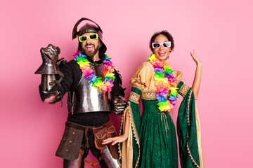 Medieval Knight and Noblewoman in Party Costumes with Colorful Accessories on Bright Pink Background