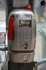90s-style telephone with a handset and a slot for coins or electronic cards