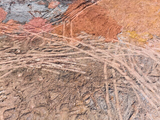 Wheel tracks on the ground on the dirt road.