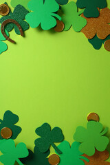 St. Patrick's Day vertical background with green and glittery shamrocks, gold coins, and a...
