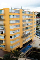Skilled construction workers repairing and restoring a building facade with precision and professionalism. The scene showcases scaffolding, safety equipment, and workers actively engaged in tasks 