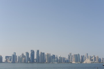 Panoramic view of modern skyscrapers of Doha capital city cityscape on a sunny day in summer, Doha,...
