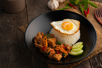 Stir Fried Canned Tuna with Thai Basil and rice topped with fried egg.asian food