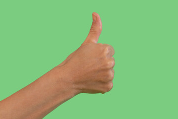 Hand gesture displaying approval against a bright green background