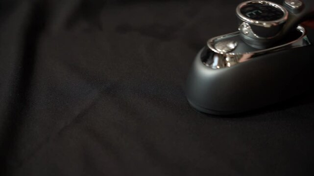 smoothing black fabric with a steamer. slow motion.