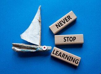 Never stop Learning symbol. Concept words Never stop Learning on wooden blocks. Beautiful blue...