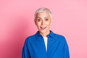 Photo of nice aged woman cant believe wear blue shirt isolated on pink color background