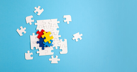 Autism Awareness Day, World Autism Day. Colorful and White Puzzles on Blue Background