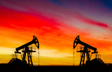Oil drilling derricks at desert oilfield. Crude oil production from the ground. Oilfield services...
