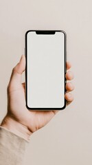 Close up view of a hand holding a smartphone featuring a blank white screen against a neutral background, offering a versatile template for various mockup designs and digital applications