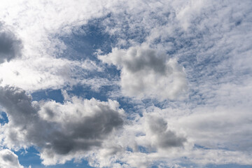Beautiful white and grey clouds on partly blue sky. Autumn shot.