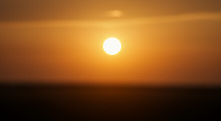 Stunning Sunset Over Horizon, Vibrant Orange Sky and Glowing Sun