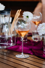 Elegant rose wine glass centerpiece with vibrant decor, perfect for celebrations and fine dining