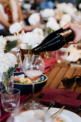 Elegant wine pouring at a beautifully set table, perfect for celebrations and fine dining moments