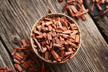 Red sandalwood chips in a bowl, top view