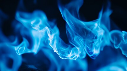 Fototapeta premium Mesmerizing blue flames dancing against a dark background