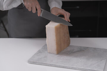 Female hands preparing a piece of lard on a light board