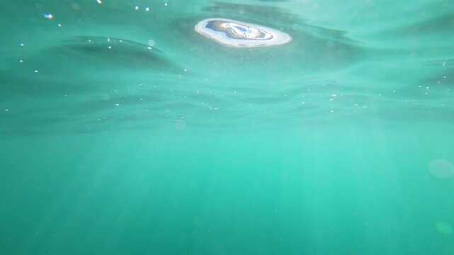 A view from just under the surface of the water on a Hawaiian Beach
