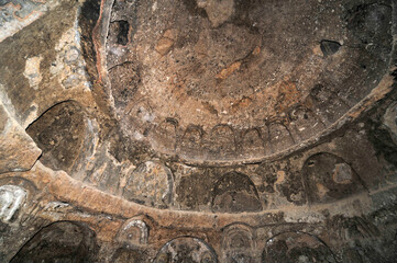 A rock with niches in which Buddha statues once stood in Bamian, Afghanistan