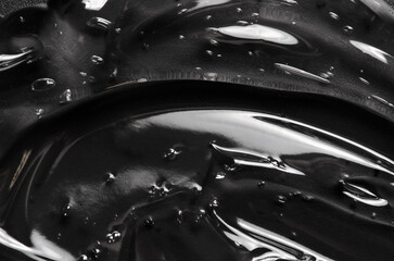 Transparent cosmetic moisturizing gel or skin serum on a black background