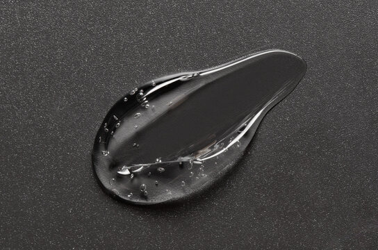 Transparent cosmetic moisturizing gel or skin serum on a black background