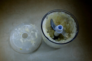 Automatic shredder for slicing. Kitchen appliances. Chopping onions, garlic. Dinner for the family