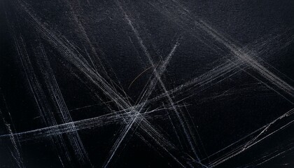 Abstract dark background with white scratches.