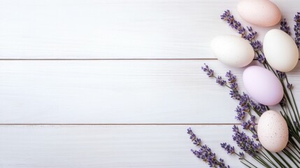 Easter decorations with pastel colored eggs and lavender on white wooden background