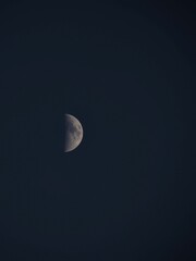Half moon in the sky at night.