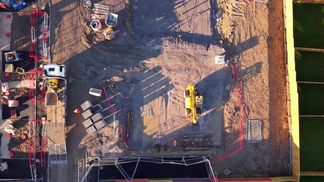 Aerial view from drone at Construction progress captured from above at a development site in the afternoon sun