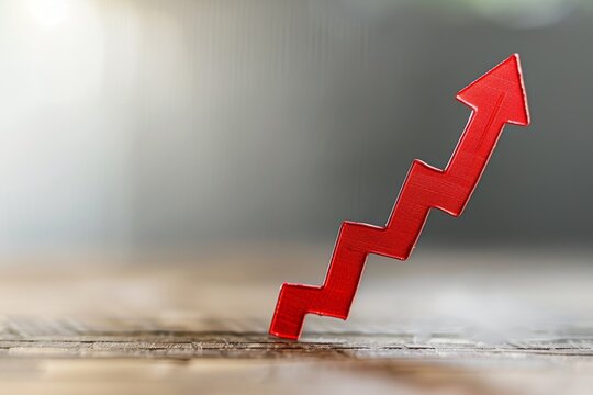 Red financial arrow going up the graph on a light background