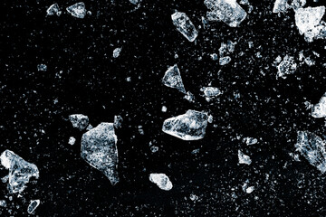 Ice, crushed on a black background. Shards of crushed ice spread away. The explosion of ice.