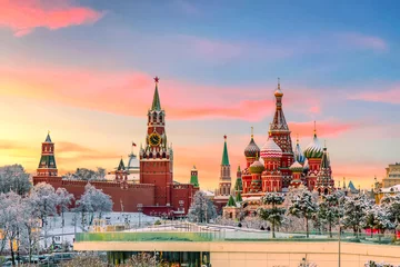Poster View of Kremlin and St. Basil Cathedral at the Red Square during sunset in winter. Famous landmarks in Moscow, Russia