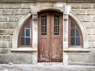 Arched old wooden doorway in the historic center of Coimbra.
