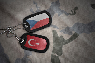 vintage army blank, dog tag with flag of czech republic and turkey on the khaki texture background....