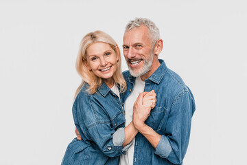 Close up of smiling beautiful couple family elderly gray-haired man blonde woman in denim shirt...