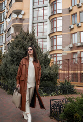 elegant woman over 40 exiting building with laptop bag