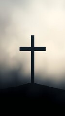 Silhouette of a cross against a hazy sky.
