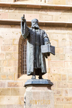 Romania, Brasov. Johannes Honterus statue. Pointing at German school. He set up major library.