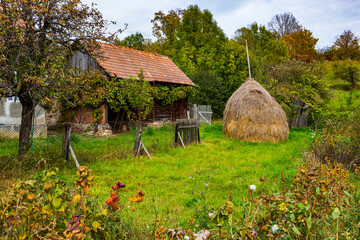 Romania, Transylvania. Old wood Romanian house next to hay stack. © Danita Delimont
