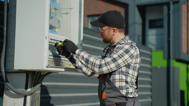 Electrician Working on Outdoor Power Box