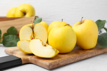 Ripe yellow apples on light grey table, closeup