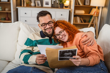 emotional couple watch ultrasonic pregnant picture of their baby